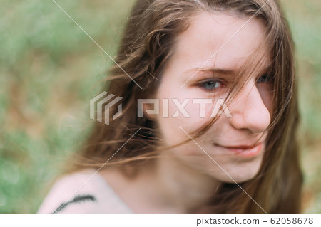 beautiful woman with flowers walking through the green forest in early spring beautiful woman with flowers walking through the green forest in early spring 62058678