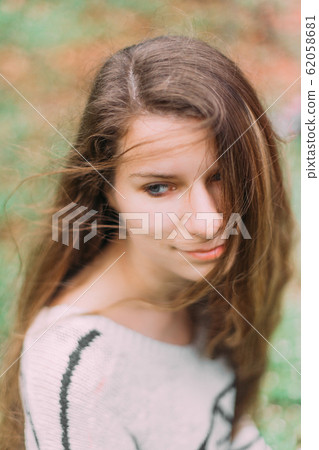 beautiful woman with flowers walking through the green forest in early spring beautiful woman with flowers walking through the green forest in early spring 62058681
