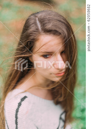 beautiful woman with flowers walking through the green forest in early spring 62058682