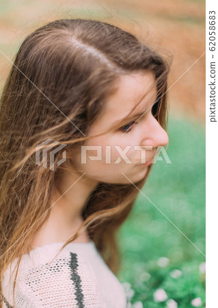 beautiful woman with flowers walking through the green forest in early spring beautiful woman with flowers walking through the green forest in early spring 62058683