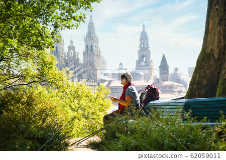 Tourist Woman On Pilgrimage At Santiago De Compostela With Phone 62059011