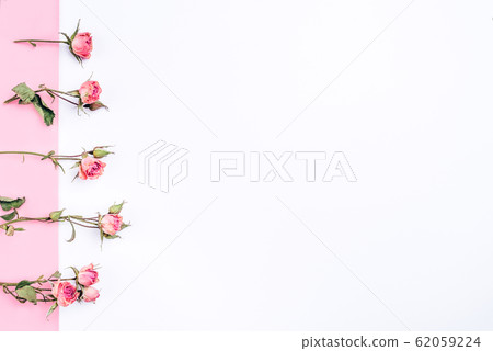 Frame of dried rose flowers on white and pink Frame of dried rose flowers on white and pink 62059224