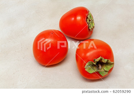 fruits of orange persimmon on the table, colorful dessert, top view fruits of orange persimmon on the table, colorful dessert, top view 62059290