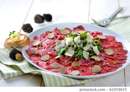 Beef carpaccio with fresh black truffles Beef carpaccio with fresh black truffles 62059655