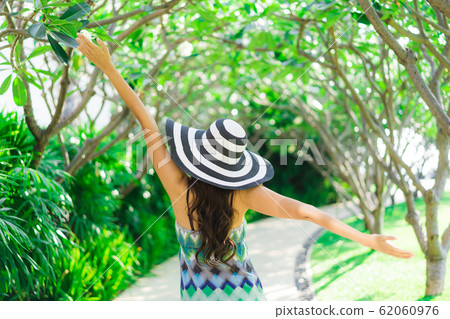 Portrait beautiful young asian woman smile and happy around outdoor garden 62060976