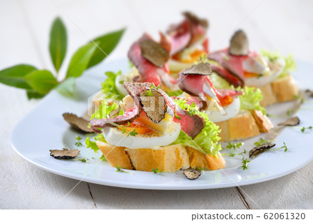 Canapes with roast beef and truffles Canapes with roast beef and truffles 62061320