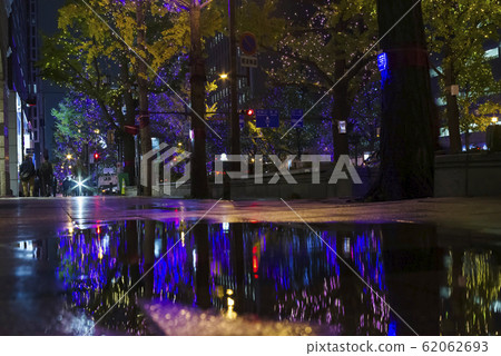 A boulevard lit up on a rainy night 62062693