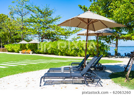 Umbrella and chair on the beach and sea with blue sky Umbrella and chair on the beach and sea with blue sky 62063260