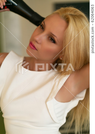 Hair Dryer. Beautiful Woman Drying Healthy Long Straight Hair Using Hairdryer 62064063