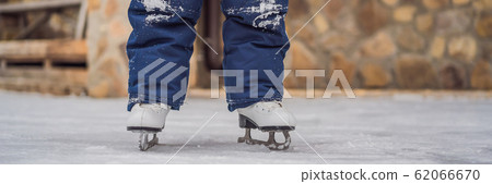 A boy just learning to ice skate BANNER, LONG FORMAT A boy just learning to ice skate BANNER, LONG FORMAT 62066670