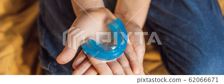 Six-year old boy shows myofunctional trainer. Helps equalize the growing teeth and correct bite Six-year old boy shows myofunctional trainer. Helps equalize the growing teeth and correct bite 62066671