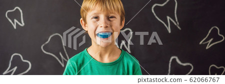 BANNER, LONG FORMAT Six-year old boy shows myofunctional trainer. Helps equalize the growing teeth 62066767