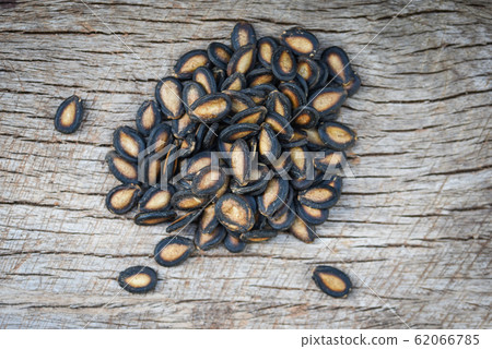 watermelon seeds on wood background / close up watermelon seeds on wood background / close up 62066785