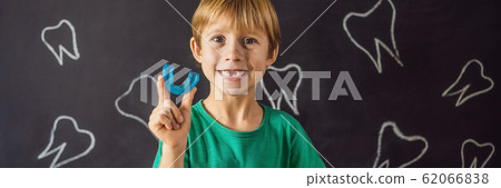 BANNER, LONG FORMAT Six-year old boy shows myofunctional trainer. Helps equalize the growing teeth BANNER, LONG FORMAT Six-year old boy shows myofunctional trainer. Helps equalize the growing teeth 62066838