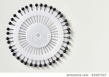 White needle bed with black pins over white 62067207
