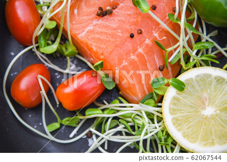 Fresh salmon fillet on dark background Fresh salmon fillet on dark background 62067544