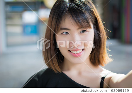 happy woman smiling face portrait; positive happy woman smiling face portrait; positive 62069159