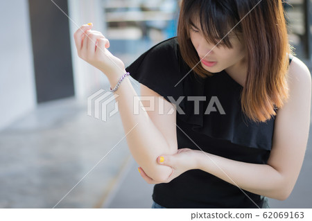 injured woman with elbow joint bone injury; injured woman with elbow joint bone injury; 62069163