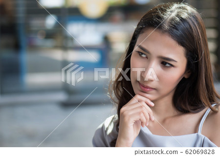 serious thoughtful woman thinking an idea; serious thoughtful woman thinking an idea; 62069828