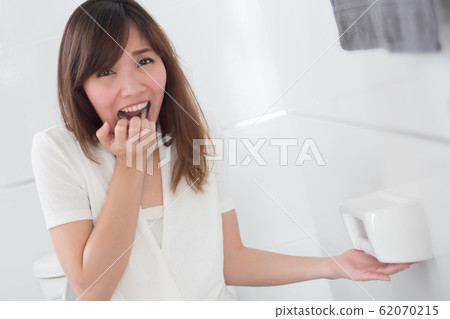 screaming woman with no toilet paper in restroom; 62070215