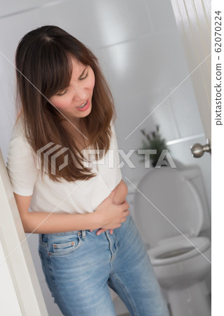 woman with diarrhea symptom; sick woman suffering 62070224