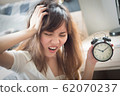 unhappy woman in trouble with late time; portrait 62070237