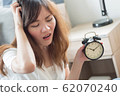 unhappy woman in trouble with late time; portrait 62070240