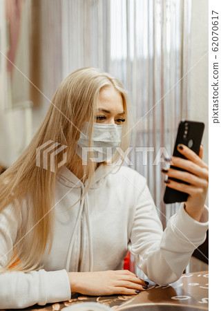 viral mask. European blonde girl in flu mask for 62070617