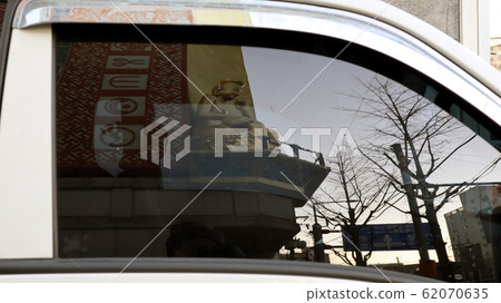 Buddha reflected in car glass 62070635