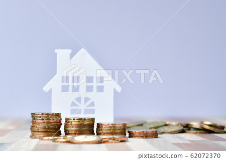 Wooden home and stack money coins of property Wooden home and stack money coins of property 62072370