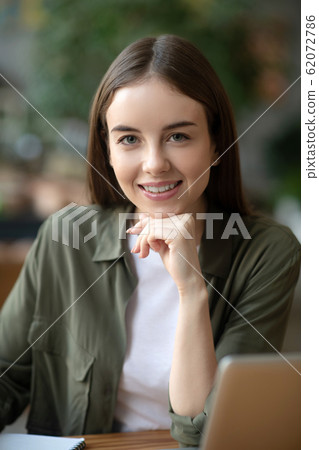Nice girl in front of a laptop. 62072786