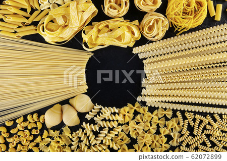 Italian pasta design with copy space, a flat lay of a variety of pasta types, shot from above on a black background with a place for text 62072899
