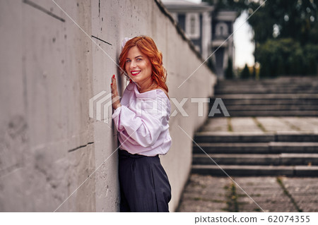 Portrait of a red-haired laughing middle-aged 62074355