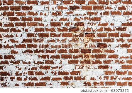 Background of old grunge brick wall texture with peeling plaster. Background of old grunge brick wall texture with peeling plaster. 62075275