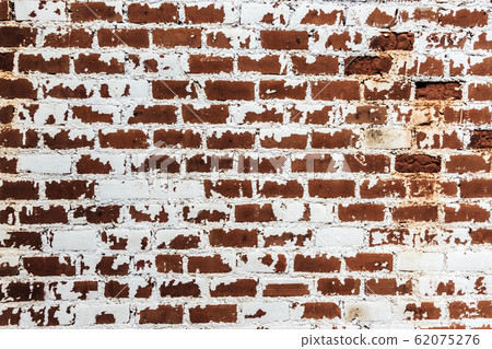 Background of old grunge brick wall texture with peeling plaster. Background of old grunge brick wall texture with peeling plaster. 62075276