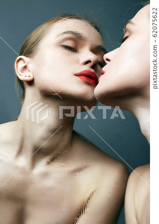 Beautiful Girl kissing wet mirror. Sensual Young 62075622