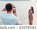Man taking foto on a the camera 62076583