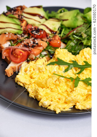 Light breakfast with fried eggs, toast with 62080170