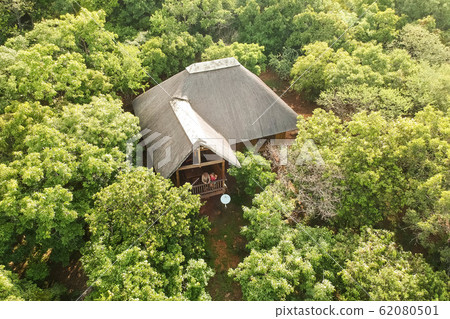 couple enjoying the view from their green bungalow 62080501