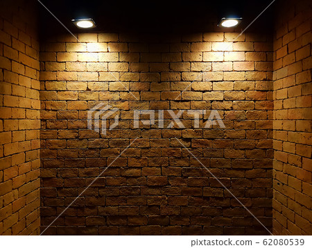 abstract old brick wall in the dark with two spotlight, warm light tone. brick wall in empty room. brick wall background for wallpaper abstract old brick wall in the dark with two spotlight, warm light tone. brick wall in empty room. brick wall background for wallpaper 62080539