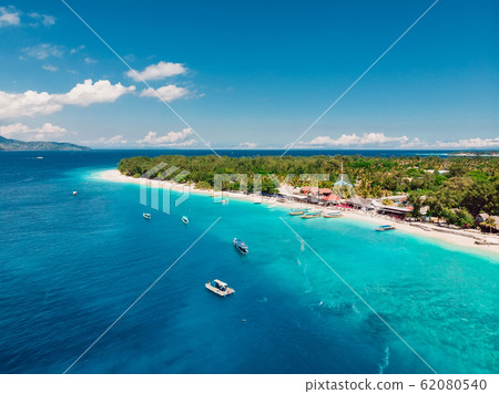 Tropical island with paradise beach and turquoise ocean. Aerial view. Tropical island with paradise beach and turquoise ocean. Aerial view. 62080540