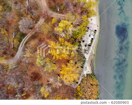Top view old abandoned concrete ship on autumn river bank 62080903