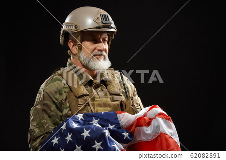 Military veteran holding american flag. 62082891