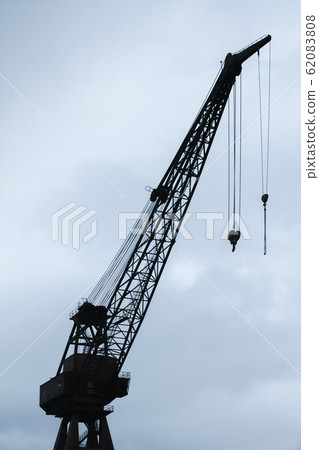 Port crane silhouette under cloudy sky Port crane silhouette under cloudy sky 62083808