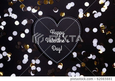 Confetti and black heart on the black background, Valentines Day, love Confetti and black heart on the black background, Valentines Day, love 62083881
