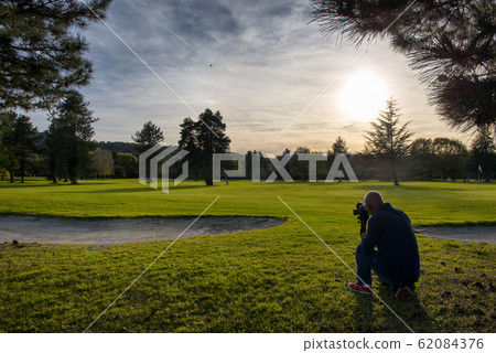 view of green golf course with photographer view of green golf course with photographer 62084376