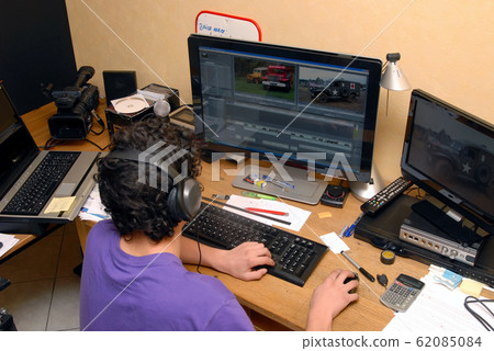 a video editor in his studio a video editor in his studio 62085084
