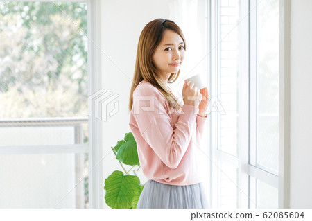 A woman drinking coffee A woman drinking coffee 62085604