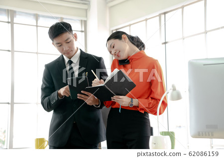 Business people using tablet and calling on phone 62086159