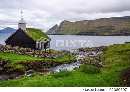 Small wooden village church on the sea shore in Faroe Islands, Denmark Small wooden village church on the sea shore in Faroe Islands, Denmark 62086807
